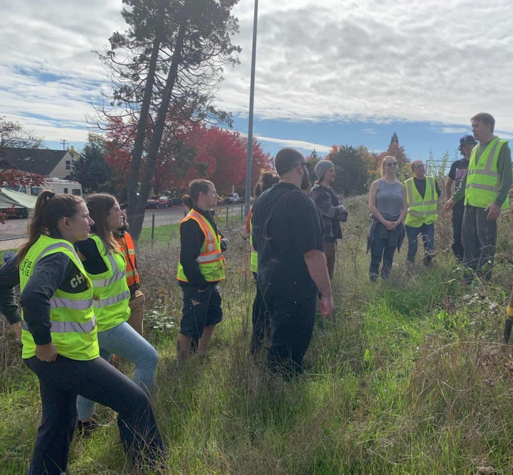 Erik from Friends of Trees Eugene pointing out the plants to remove.|A praying mantis in one of the 18 tree pots that were cleared.|FOT Tree Care 2019|Erik from Friends of Trees Eugene pointing out the plants to remove.